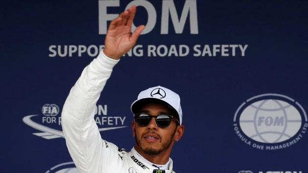 Mercedes F1 team’s Lewis Hamilton celebrates after taking pole position in qualifying for the Formula One Japanese Grand Prix at the Suzuka Circuit on Saturday.(REUTERS)