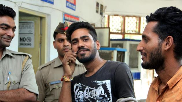 An accused poses for a picture outside the office of SP (rural) in Ghaziabad on Friday as policemen share the joke and laugh. (HT Photo) An accused poses for a picture outside the office of SP (rural) in Ghaziabad on Friday as policemen share the joke and laugh. (HT Photo)