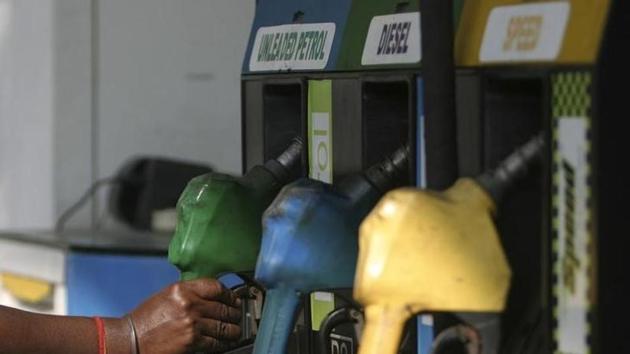 An attendant lifts a petrol nozzle at a petrol pump in Siliguri. (Reuters File)