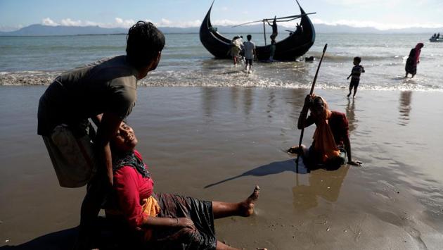 Rohingya refugees collapse from exhaustion as they arrive by a small wooden boat from Myanmar to the shore of Shah Porir Dwip in Teknaf, near Cox's Bazar in Bangladesh. (Damir Sagolj / REUTERS) Rohingya refugees collapse from exhaustion as they arrive by a small wooden boat from Myanmar to the shore of Shah Porir Dwip in Teknaf, near Cox's Bazar in Bangladesh. (Damir Sagolj / REUTERS)