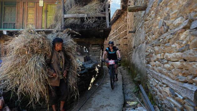 Karen Hill of Australia competes in the 13th edition of the Hero MTB Himalaya mountain bike race in Kangra district, Himachal Pradesh. The cyclists rode through narrow lanes in the villages at the foothills of the Himalayas along side the lush valleys and rivers. (AFP / SAJJAD HUSSAIN) Karen Hill of Australia competes in the 13th edition of the Hero MTB Himalaya mountain bike race in Kangra district, Himachal Pradesh. The cyclists rode through narrow lanes in the villages at the foothills of the Himalayas along side the lush valleys and rivers. (AFP / SAJJAD HUSSAIN)