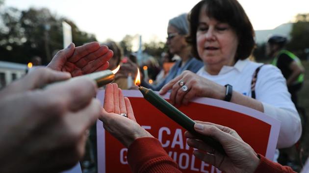 People light candles during a vigil in Newtown, Connecticut, remembering the 58 people killed in Sunday's shooting in Las Vegas on October 1. (AFP) People light candles during a vigil in Newtown, Connecticut, remembering the 58 people killed in Sunday's shooting in Las Vegas on October 1. (AFP)