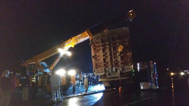 The police had to call for a crane and work for hours before the men who were stuck in the truck were rescued. (HT PHOTO) The police had to call for a crane and work for hours before the men who were stuck in the truck were rescued. (HT PHOTO)