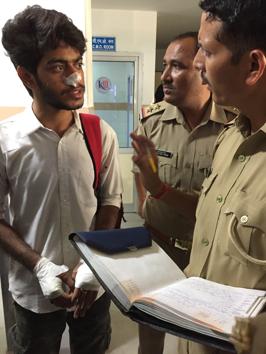 Jayesh, one of the accident survivors, speaks with the police after being discharged from the hospital on Sunday.(HT Photo)