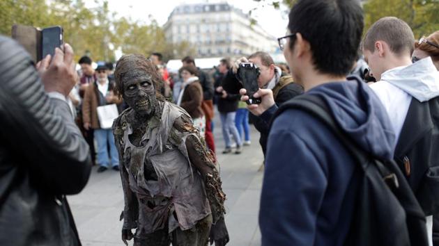 A participant poses for onlookers as he attends the Zombie Walk. (AFP)