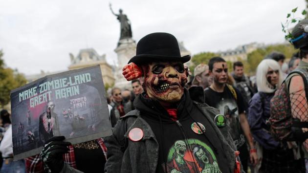 Participants attend the Zombie Walk in Paris. People are asked to donate non-perishable food for local food banks before participating in the walk. (AFP)