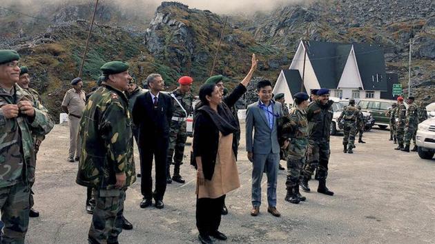Union defence minister Nirmala Sitharaman at Nathu La. The minister posted on her Twitter handle that she was acknowledging a row of Chinese soldiers from across the fence who were taking pictures on her arrival.(PTI Photo)