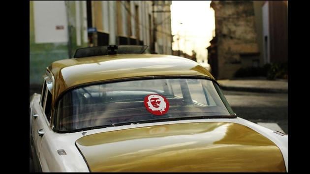 A vintage American car displays a symbol of Che Guevara in Santiago de Cuba. From wall murals, to posters and publication of his writings worldwide, Guevara today is seen as an embodiment of defiance against injustice and the rule of the imperialists. (Spencer Platt / Getty Images)