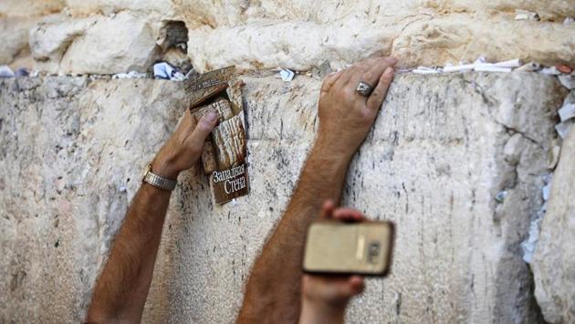 Jewish worshippers touch the stones of the Western Wall in Jerusalem’s Old City. The holiday lasts for seven days in Israel while among Jewish diaspora, it lasts up to eight days - beginning and ending with a Sabbat. (Amir Cohen / REUTERS)