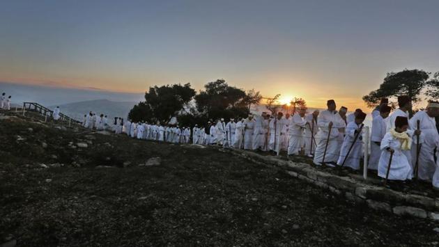 Samaritans walk up to pray on Mount Gerizim, near the city of Nablus, during the Sukkot festival. Samaritans are a community of a few hundred people living in Israel and in the Nablus area, who trace their lineage to the ancient Israelites Moses led out of Egypt. (Jaffar Ashtiyeh / AFP)