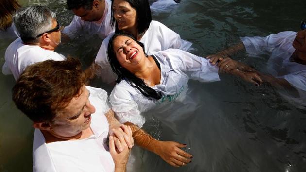 Evangelical Christian pilgrims from Brazil attend a mass baptism ceremony in the waters of the Jordan River at Yardenit in northern Israel during the Jewish holiday. According to the gospel Jesus Christ was baptized in the water of the Jordan River by John the Baptist. (Menahem Kahana / AFP)