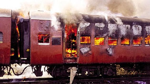 Smoke bellows from the carriage of a train on fire in Godhra, Gujarat.(Reuters File Photo)