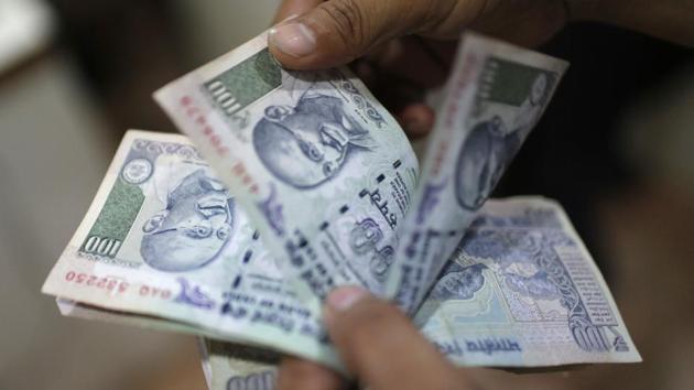 An employee counts Indian rupee currency notes inside a private money exchange office in New Delhi. (Reuters File) An employee counts Indian rupee currency notes inside a private money exchange office in New Delhi. (Reuters File)