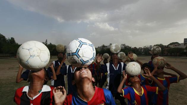 Young boys and girls from a slum in Delhi’s Vikaspuri area are taking to football, trained by Sylvester Peter, who runs ‘My Angels Academy.’ The academy is not just a football club, rather a way out of the slums for these children. (RAJ K RAJ / HT PHOTO)