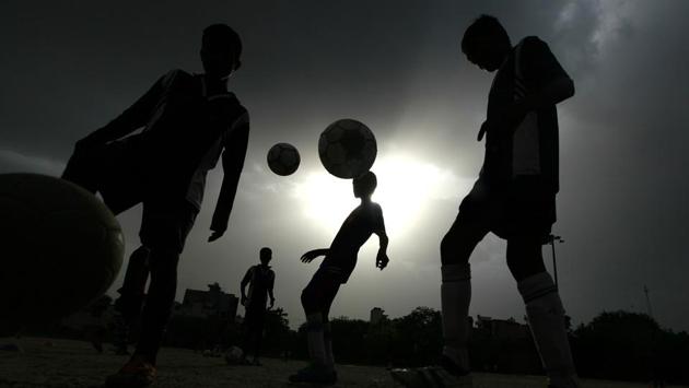 Thanks to their football coach Sylvester, who is lovingly called ‘bhaiyya’ by the slum’s residents, many young have not been sucked into drug peddling, anti-social activities, rag picking or politics. (RAJ K RAJ / HT PHOTO)
