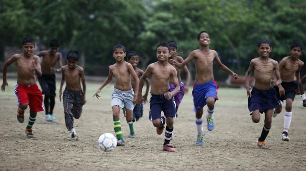 Every morning at 4 am, the young footballers, which includes several girls, practice in the local park in Vikaspuri, making it an inclusive space and a way out of the slums for these young children. (RAJ K RAJ / HT PHOTO)