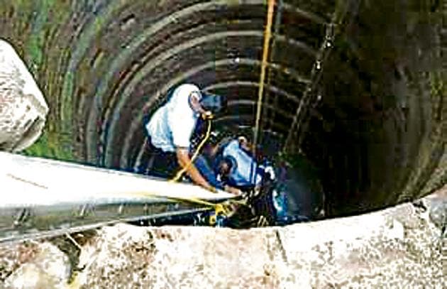 Two firemen were lowered into the well to check the animal for major injuries. (HT photo) Two firemen were lowered into the well to check the animal for major injuries. (HT photo)