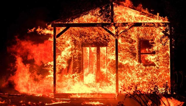 Flames overtake a structure as nearby homes burn in the Napa wine region in California on October 9, 2017, as multiple wind-driven fires continue to whip through the region. (AFP) Flames overtake a structure as nearby homes burn in the Napa wine region in California on October 9, 2017, as multiple wind-driven fires continue to whip through the region. (AFP)