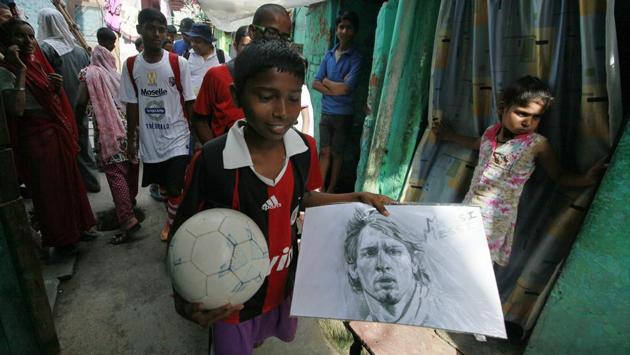 In the narrow lanes of the basti in Vikaspuri, little Sameer shows off a sketch he’s made of his icon, Lionel Messi. This exercise to make the kids play football has transformed the entire mindset of this class driven society. Today many young underprivileged boys and girls – even from orthodox families, can be seen playing football in the wee hours of the morning without any fear and discrimination. (RAJ K RAJ / HT PHOTO)