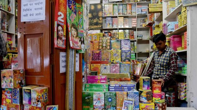 A shopkeeper at his firecracker shop in New Delhi. The Supreme Court has put on hold sale of firecrackers in Delhi-NCR till November 1.(AFP Photo)