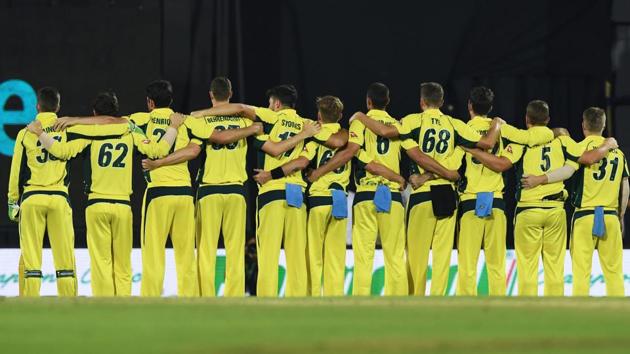 Australia's players stand during the national anthem ahead of the second T20 match hosted by the Assam Cricket Association in Guwahati on October 10, 2017. The Australian team bus was attacked with a stone after the visitors beat India to level the three-match series 1-1.(AFP)