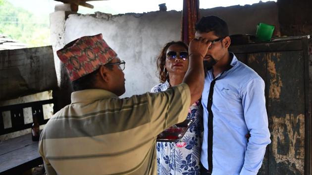 Monika Shahi Nath Yogi's father-in-law welcomes her and her husband at Kain Pani village in Nepal's Dadeldhura district. The couple have found a rare acceptance in Nepal, where many transgender people still struggle to be open about their identity despite progressive laws that include a third gender option on identity cards and passports. (Prakash Mathema / AFP)