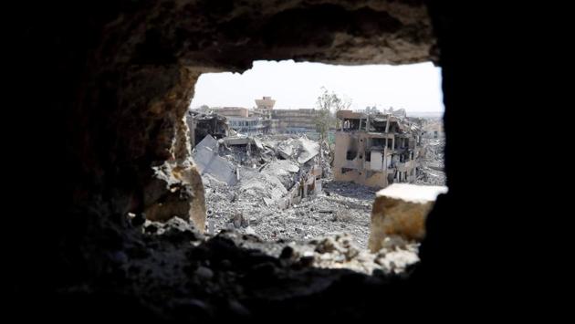 The Raqqa National Hospital, the last ISIS stronghold is pictured from a hole at the positions of the SDF at the frontline in Raqqa. In a gutted four-storey building turned into a fortress, Babel (his nom de guerre) and fellow SDF fighters can peer out at Islamic State positions just 150 metres away. (Erik De Castro / REUTERS) The Raqqa National Hospital, the last ISIS stronghold is pictured from a hole at the positions of the SDF at the frontline in Raqqa. In a gutted four-storey building turned into a fortress, Babel (his nom de guerre) and fellow SDF fighters can peer out at Islamic State positions just 150 metres away. (Erik De Castro / REUTERS)