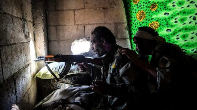 Members of the Syrian Democratic Forces (SDF), take position inside a building on the eastern frontline of Raqqa. With about 90% recaptured, US-backed fighters in northern Syria are preparing for a final offensive on pockets still held by the Islamic State, Mustafa Bali of the Kurdish-led Syrian Democratic Forces told AP on Monday. Brett McGurk, the top U.S. envoy for the anti-Islamic State coalition also affirmed that the battle for Raqqa is now approaching its last phase. (Bulent Kilic / AFP) Members of the Syrian Democratic Forces (SDF), take position inside a building on the eastern frontline of Raqqa. With about 90% recaptured, US-backed fighters in northern Syria are preparing for a final offensive on pockets still held by the Islamic State, Mustafa Bali of the Kurdish-led Syrian Democratic Forces told AP on Monday. Brett McGurk, the top U.S. envoy for the anti-Islamic State coalition also affirmed that the battle for Raqqa is now approaching its last phase. (Bulent Kilic / AFP)