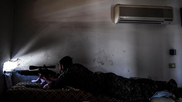 A member of the SDF, monitors ISIS positions on the western frontline in Raqqa. SDF are battling to clear the last remaining holed up jihadists, expected to make a last stand for their self-proclaimed caliphate --now cornered and desperate-- in Raqqa, the city on the Euphrates river that has served as their de-facto Syrian capital since 2014. (Bulent Kilic / AFP) A member of the SDF, monitors ISIS positions on the western frontline in Raqqa. SDF are battling to clear the last remaining holed up jihadists, expected to make a last stand for their self-proclaimed caliphate --now cornered and desperate-- in Raqqa, the city on the Euphrates river that has served as their de-facto Syrian capital since 2014. (Bulent Kilic / AFP)