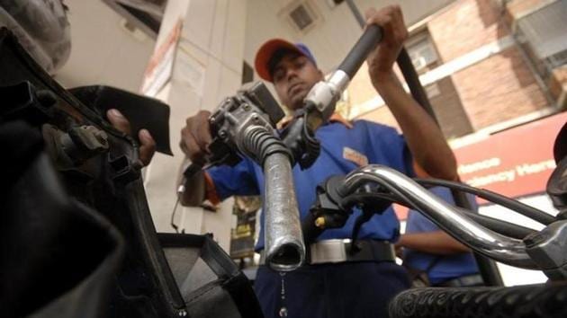 A worker holds a fuel nozzle at a petrol pump in Hyderabad. (Reuters File) A worker holds a fuel nozzle at a petrol pump in Hyderabad. (Reuters File)