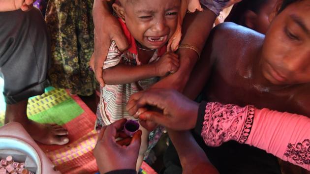 A child cries as a Bangladeshi volunteer inks his finger after administering an oral cholera vaccine in Ukhia district. The disease often strikes regions steeped in conflict that lack sanitation and in areas where malnutrition runs rampant. International relief agencies are scrambling to meet the needs for shelter, water and medical care for refugees in overcrowded camps. (Indranil Mukherjee / AFP ) A child cries as a Bangladeshi volunteer inks his finger after administering an oral cholera vaccine in Ukhia district. The disease often strikes regions steeped in conflict that lack sanitation and in areas where malnutrition runs rampant. International relief agencies are scrambling to meet the needs for shelter, water and medical care for refugees in overcrowded camps. (Indranil Mukherjee / AFP )