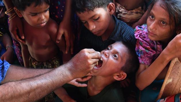 Rohingya refugee children look on as a Bangladeshi volunteer administers an oral cholera vaccine at a refugee camp. The World Health Organisation (WHO) on Tuesday launched a pre-emptive oral cholera vaccination campaign, the second largest ever in history after Haiti’s in 2016, at camps inhabited by the Rohingya anticipating a possible outbreak. (Indranil Mukherjee / AFP ) Rohingya refugee children look on as a Bangladeshi volunteer administers an oral cholera vaccine at a refugee camp. The World Health Organisation (WHO) on Tuesday launched a pre-emptive oral cholera vaccination campaign, the second largest ever in history after Haiti’s in 2016, at camps inhabited by the Rohingya anticipating a possible outbreak. (Indranil Mukherjee / AFP )