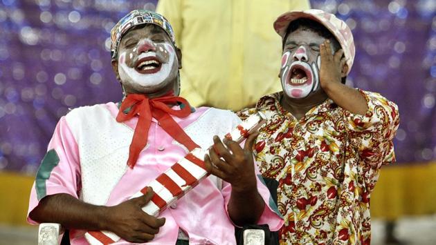 Two clowns share a light moment at the Asiad Circus, while on tour in east Delhi. One of the most popular acts in the circus, clowns, ironically, find little acceptance in the world outside a circus. (Sanchit Khanna / HT PHOTO)