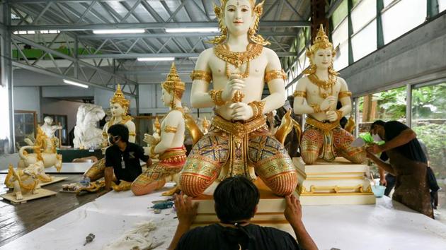 Artists work on deity sculptures which will decorate the funeral pyre of the late King Adulyadej, near the Grand Palace in Bangkok. More than 3,000 performers will join in a nightlong final tribute of music and puppet shows to end a year of mourning. Thais devoted to the memory of the king have folded paper flowers for his cremation, making 10 million in Bangkok alone, city authorities said. (Athit Perawongmetha / REUTERS) Artists work on deity sculptures which will decorate the funeral pyre of the late King Adulyadej, near the Grand Palace in Bangkok. More than 3,000 performers will join in a nightlong final tribute of music and puppet shows to end a year of mourning. Thais devoted to the memory of the king have folded paper flowers for his cremation, making 10 million in Bangkok alone, city authorities said. (Athit Perawongmetha / REUTERS)