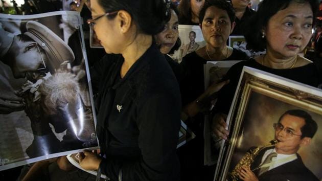 Well-wishers hold pictures of the late King Bhumibol Adulyadej on the last day the authorities allow people to pay their respect to the late king in the throne hall in Bangkok. Hundreds of thousands of black-clad mourners are expected to camp for days near Bangkok’s Grand Palace to catch a glimpse of the ceremonies, which will be guarded by 78,000 police officers and culminate in the cremation on October 26. (Athit Perawongmetha / REUTERS) Well-wishers hold pictures of the late King Bhumibol Adulyadej on the last day the authorities allow people to pay their respect to the late king in the throne hall in Bangkok. Hundreds of thousands of black-clad mourners are expected to camp for days near Bangkok’s Grand Palace to catch a glimpse of the ceremonies, which will be guarded by 78,000 police officers and culminate in the cremation on October 26. (Athit Perawongmetha / REUTERS)