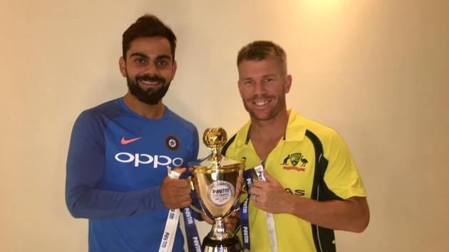 India captain Virat Kohli and Australia skipper David Warner share the T20I trophy after the India vs Australia game was abandoned due to a wet outfield.(Indian cricket team Facebook)