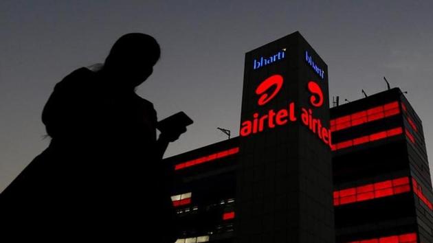 A girl checks her mobile phone as she walks past the Bharti Airtel office building in Gurugram on the outskirts of New Delhi, India April 21, 2016.(Reuters)
