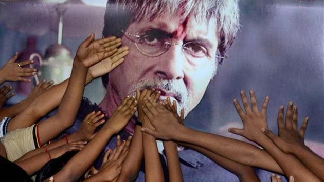 Children greeting actor Amitabh Bachchan on his 75th birthday through his poster in Kolkata on Wednesday. (PTI)