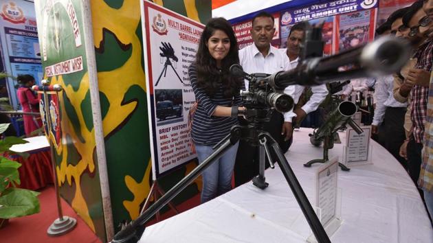 A Dayal Singh college student handles a multi-barrel launcher on display at the BSF Annual Welfare Meet and Exhibition 2017 in New Delhi. (Raj K Raj / HT PHOTO)