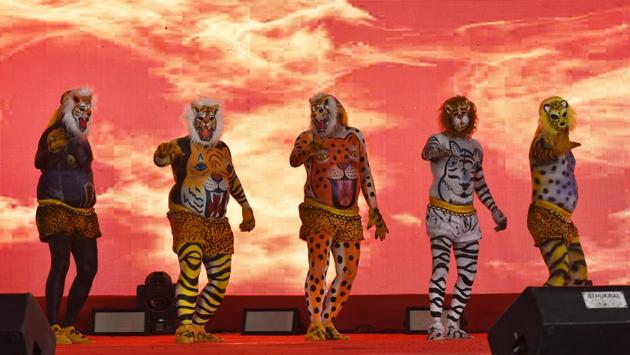 BSF officers perform on stage in ‘huli vesa,’ where the body of a tiger is painted on the body and a mask is worn on the face. (Raj K Raj / HT PHOTO)