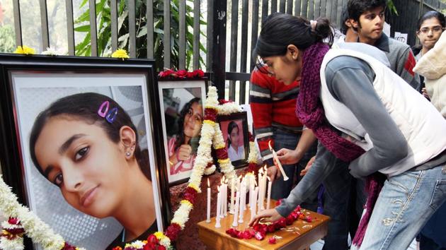 In this file photo friends and relatives of Aarushi Talwar light candles near her portrait to seek justice for her at Jantar Mantar in New Delhi in Jan 2011.(HT File Photo)