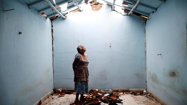 Tomasa Mozo, 69, a housewife, looks up at the roof inside the ruins of her house after the earthquake that struck Mexico in September. Her house was badly damaged but with the help of family Mozo rescued some furniture. She lives in another room of her house and hopes to repair the damage as soon as possible. ‘I’m afraid to go out, I can not sleep,’ Mozo said. (Edgard Garrido / REUTERS)