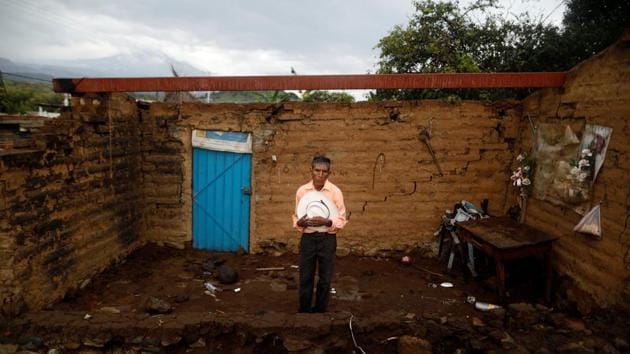 Prudencio Gutierrez, 66, a farm worker, in front of his damaged house in San Francisco Xochiteopan, Mexico. Gutierrez’s house was badly damaged but he was able to rescue his bed and some clothing. ‘The most valuable thing that I recovered was my hat,’ he said. Rubble is all that remains of hundreds of houses rent asunder, leaving owners lodging with relatives or friends, hoping their homes can be rebuilt or they can find new ones. (Edgard Garrido / REUTERS)