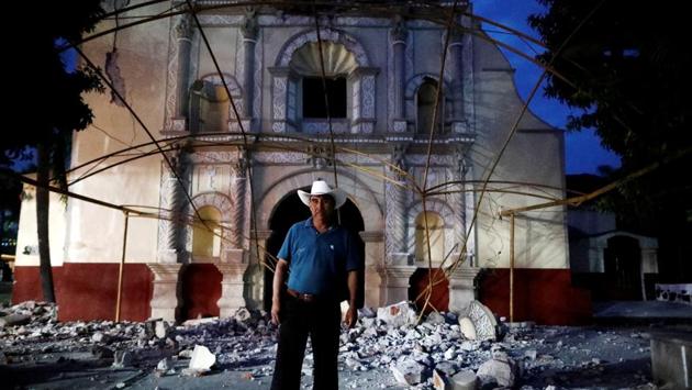 Juan Sanchez, 53, a parishioner and a church guard, in front of San Juan Bautista church near the epicentre zone in Mexico. His house wasn’t damaged so he has offered shelter to some families in his backyard. ‘We are holding mass under a tent. It is a great sadness, we are waiting for the government’s help to rebuild our church,’ Sanchez said. (Edgard Garrido / REUTERS)