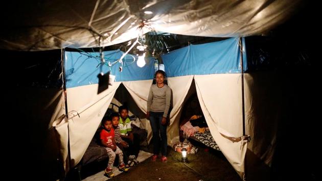 Veronica Dircio, 34, a housewife, poses with her sons in front of a tent in a neighbour’s backyard –her home after the earthquake. Dircio’s house was badly damaged. ‘We’re worried because they (authorities) came and did a census of the homes; and whether it’s a big house or a small house, they haven’t told us if we’re at least going to be able to get back a bit of what was once our house,’ Dircio added. (Edgard Garrido / REUTERS)