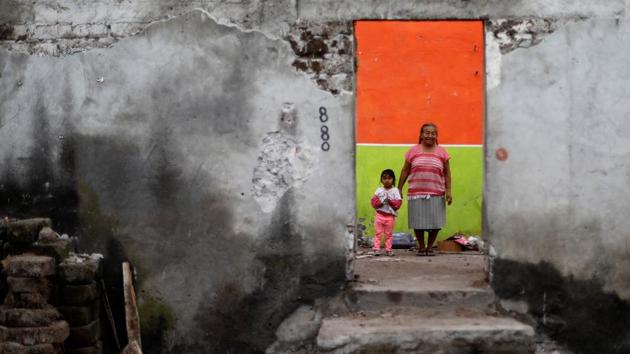 Elena Zapata, 69, a housewife, poses for a portrait with her granddaughter Mariana, 3, inside the ruins of her house in Tepalcingo, Mexico. She lives in her backyard and hopes to return when the damage is repaired. ‘The most valuable that I have is the life of my granddaughter. We hope the authorities come to visit us. I feel anguish, I hear noises, I just want to cry,’ Zapata said. (Edgard Garrido / REUTERS)