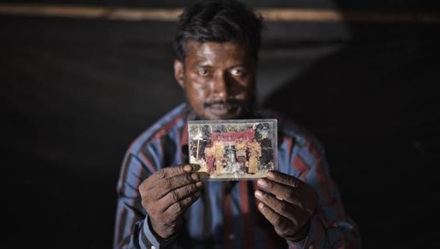 The only personal possession Amir Hussain could carry with him during his arduous passage to India in 2009 was a family photograph. Most Rohingyas who flee Myanmar arrive with nothing other than legal documents and with rigs of clothes on their backs. (Burhaan Kinu / HT PHOTO)