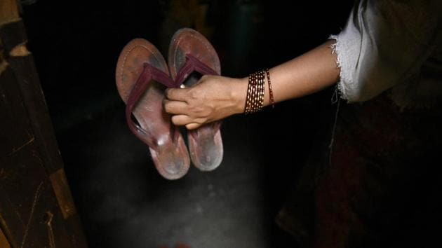 Sabera Khatun shows a pair of slippers, which she brought with her when she fled her home in Myanmar and came to India. (Burhaan Kinu / HT PHOTO)