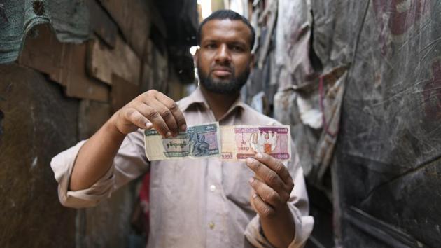 Mohammad Salimullah, one of the two Rohingya refugees who have petitioned the Supreme Court about the proposed deportation of the refugees from India, shows the Burmese currency notes which he had brought with him while fleeing his country in 2012. The Supreme Court of India has urged the petitioners to desist from making emotional arguments and personal attacks and to file documents, including international conventions. (Burhaan Kinu / HT PHOTO)