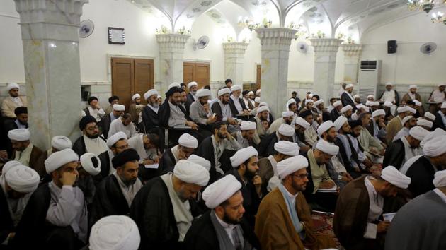 Shi’ite clerics study at al-Gharawiya school run by the Hawza al-Ilmiyya in Najaf, Iraq. In the Najaf school, a typical day will see clerics in flowing black robes and white turbans giving lectures to groups of students sitting on the floor of a great hall, lined with pointed arches and elaborate mosaics (Abdullah Dhiaa Al-deen / REUTERS)